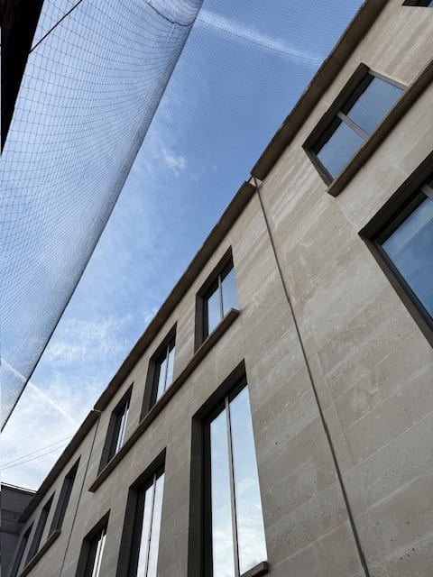 Bird netting above a lightwell with skylights below