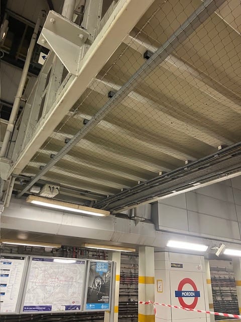 Bird netting fitted beneath a station platform canopy